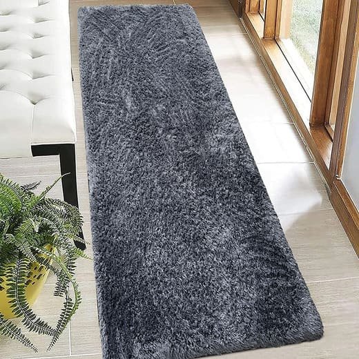 Tapete passadeira em lã sintética, felpudo, ultra macio com tecnologia anti-derramamento de fibras e base antiderrapante. Possui toque aveludado de alta densidade, sendo ideal para corredores, quartos (beira de cama). Cor: Cinza Grafite